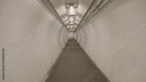 Montreal, QC, Canada - November 15, 2017: Walking on pedestrian underground tunnel, linking Herron Rd and Cardinal Ave, under highway Autoroute 20. photo