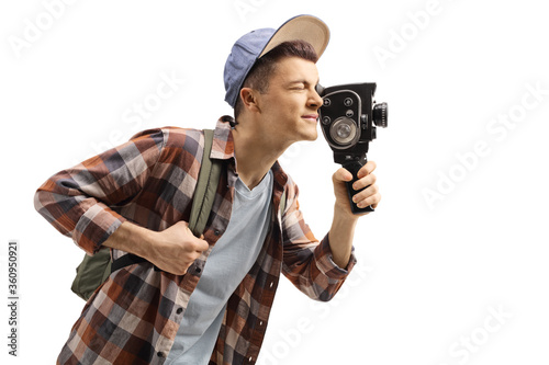 Male student with a backpack recording with a vintage 8mm camera