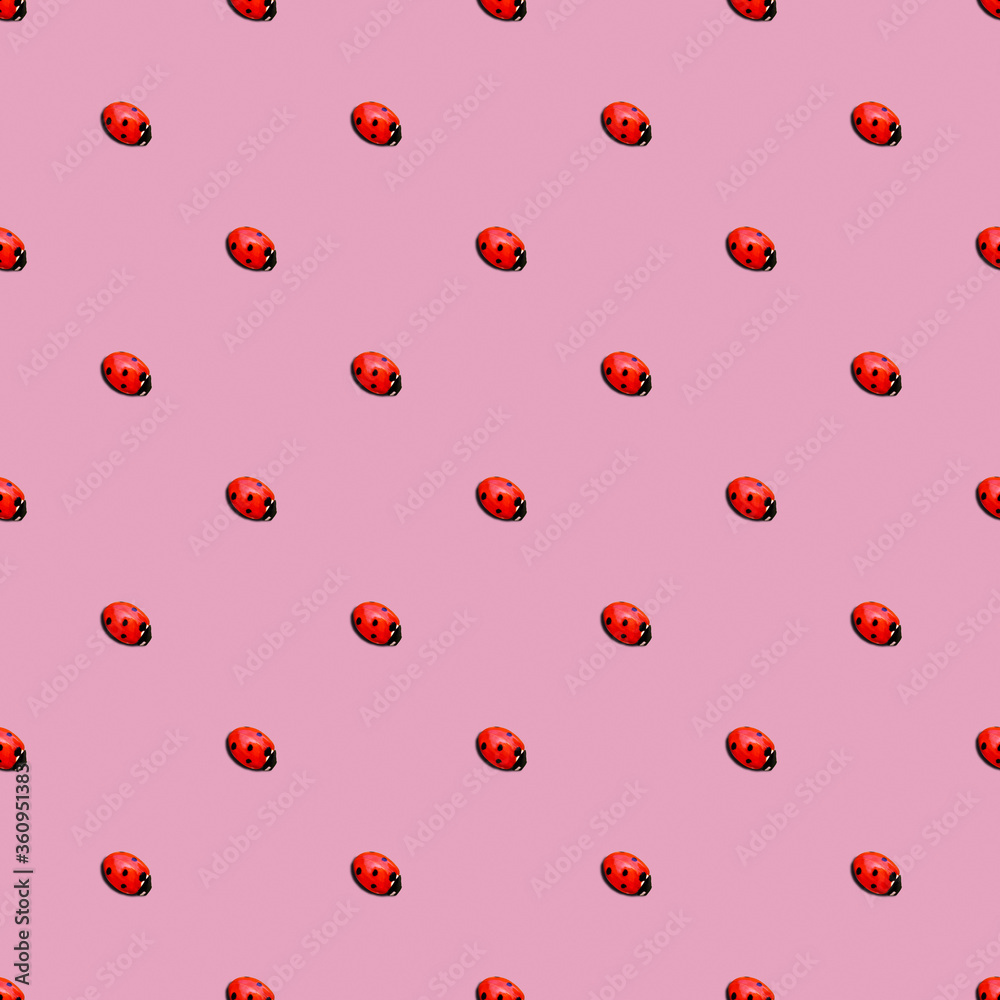 ladybug or ladybird seamless pattern isolated over pink background. minimal summer concept. ladybug or ladybird seamless pattern isolated over pink background. minimal summer concept.
