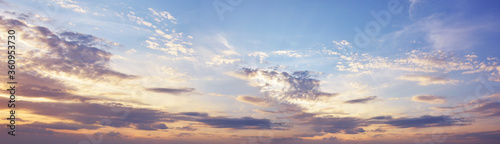 Sky at sunset with dark clouds, panoramic big shot. Background from the cloudy sky © ArturSniezhyn