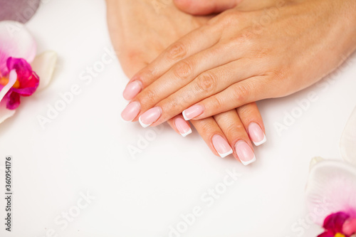 Nail care, woman demonstrates a fresh manicure done in a beauty studio