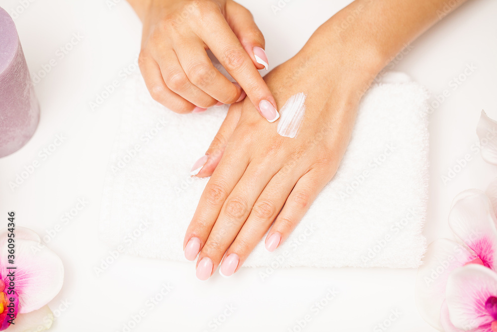 Hand skin care, woman applies moisturizer on soft silky skin