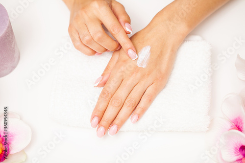 Hand skin care, woman applies moisturizer on soft silky skin