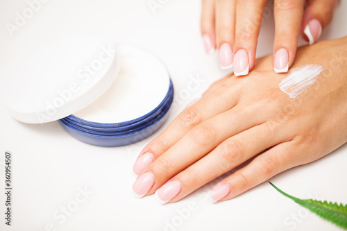 Hand skin care  woman applies moisturizer on soft silky skin