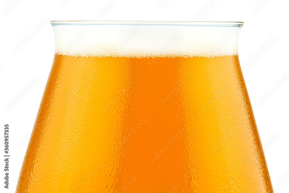 Macro shot of cold beer in a Teku tasting glass filled to full with foam, drops of water on glass, the upper part of the glass is visible, isolated on a white background with a clipping path. Macro shot of cold beer in a Teku tasting glass filled to full with foam, drops of water on glass, the upper part of the glass is visible, isolated on a white background with a clipping path.