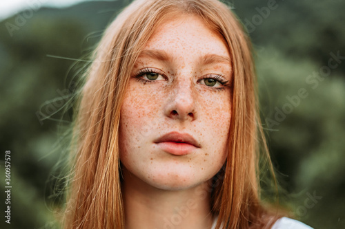 Close-up portrait of young teen freckled ginger girl