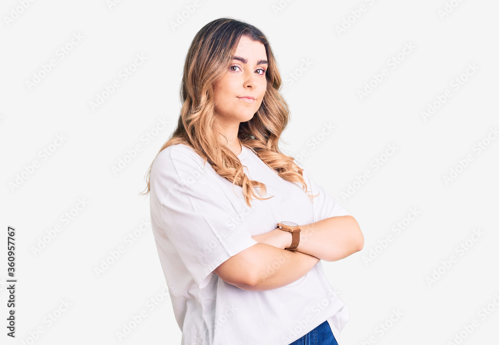 Young caucasian woman wearing casual clothes looking to the side with arms crossed convinced and confident Young caucasian woman wearing casual clothes looking to the side with arms crossed convinced and confident
