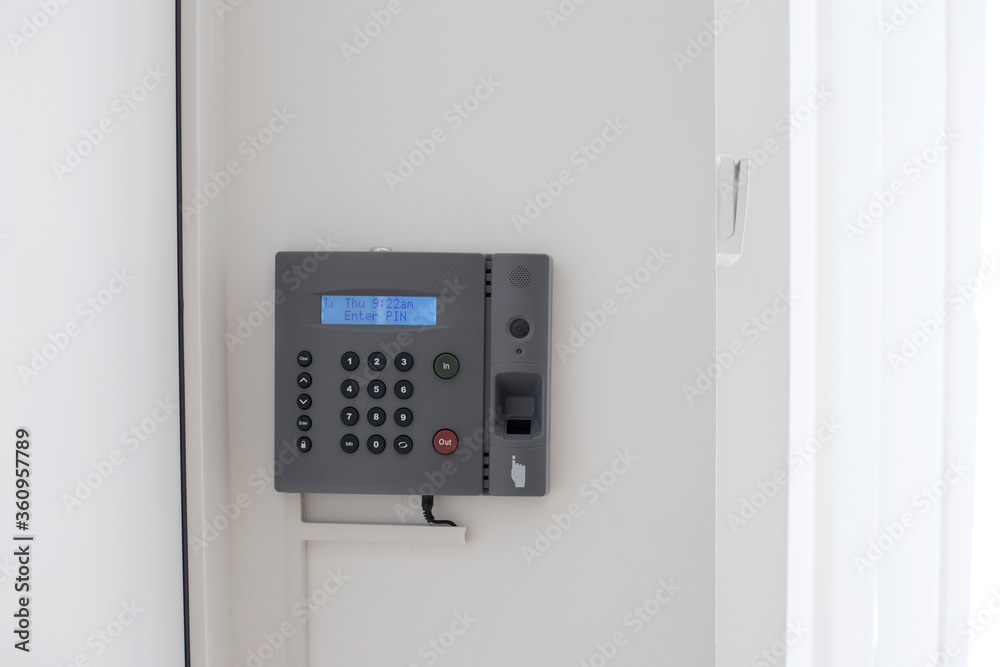 Small business biometric scanner. Electronic authorization equipment on the white wall
