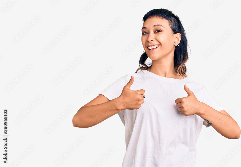 Young woman wearing casual clothes success sign doing positive gesture with hand, thumbs up smiling and happy. cheerful expression and winner gesture. Young woman wearing casual clothes success sign doing positive gesture with hand, thumbs up smiling and happy. cheerful expression and winner gesture.