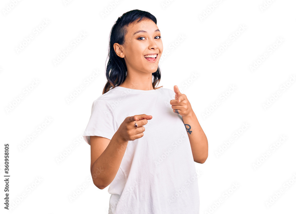 Young woman wearing casual clothes pointing fingers to camera with happy and funny face. good energy and vibes. Young woman wearing casual clothes pointing fingers to camera with happy and funny face. good energy and vibes.