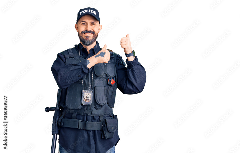 Young handsome man wearing police uniform pointing to the back behind with hand and thumbs up, smiling confident Young handsome man wearing police uniform pointing to the back behind with hand and thumbs up, smiling confident