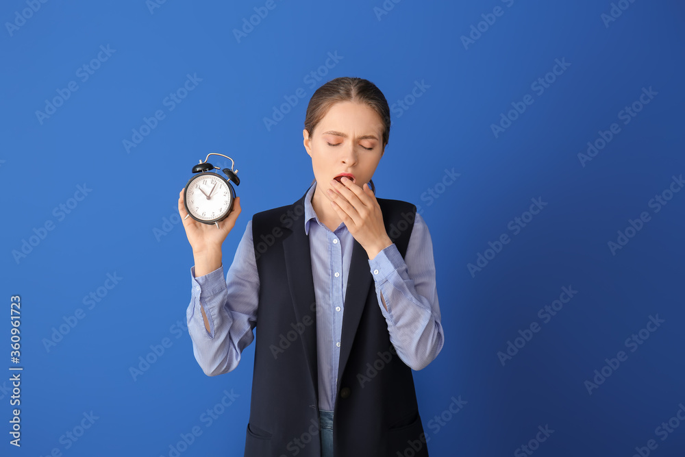 Tired woman with alarm clock on color background. Concept of sleep deprivation Tired woman with alarm clock on color background. Concept of sleep deprivation