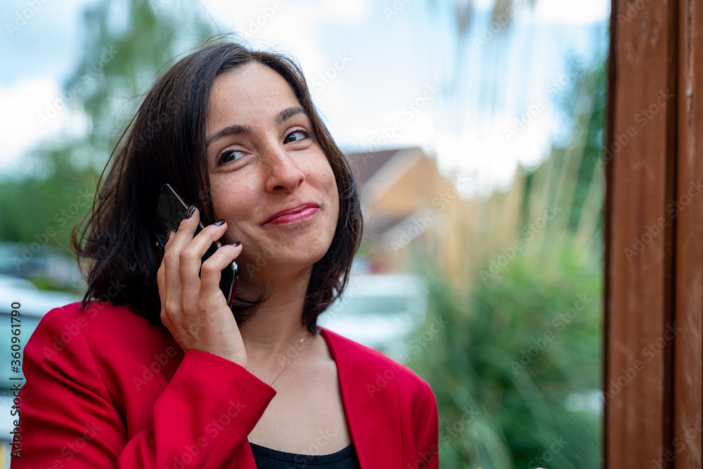 Young business woman speaking on the phone. Getting happy news. Business and technology concept Young business woman speaking on the phone. Getting happy news. Business and technology concept