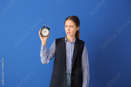 Tired woman with alarm cloc...