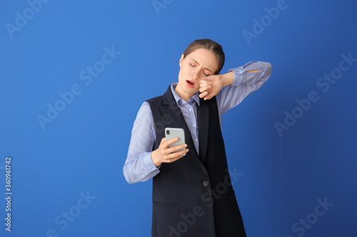 Tired woman with mobile pho...