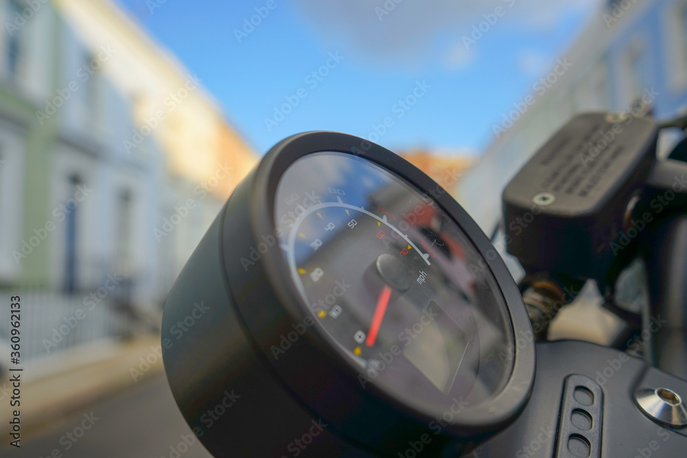 Motorcycle speedo on a beautiful sunny day on a colorful pastel street of London Motorcycle speedo on a beautiful sunny day on a colorful pastel street of London
