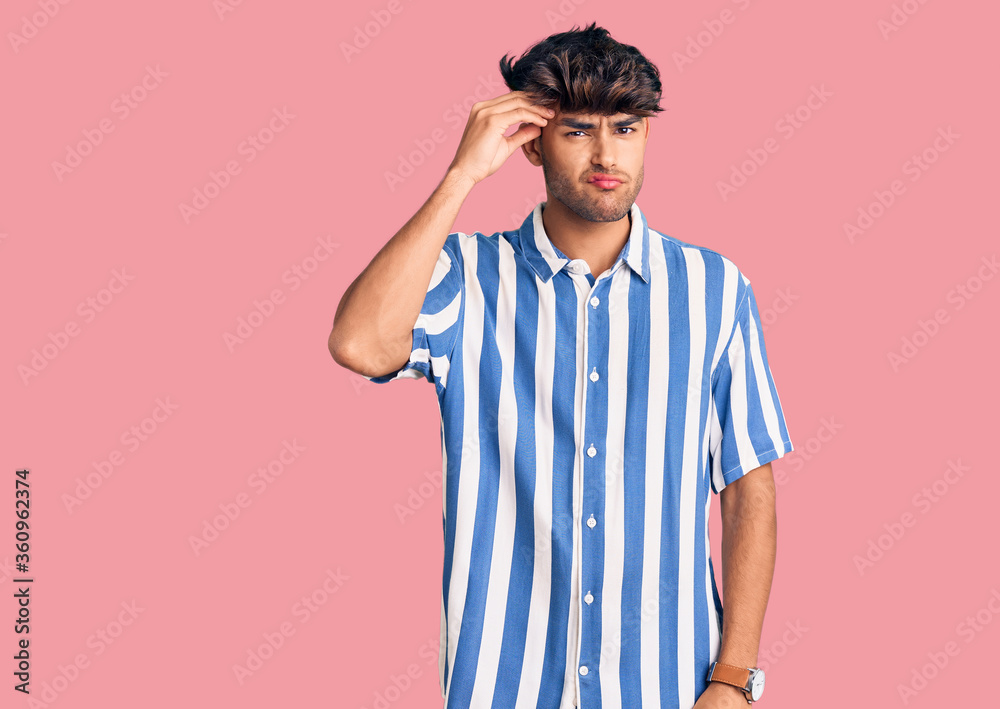 Young hispanic man wearing casual clothes worried and stressed about a problem with hand on forehead, nervous and anxious for crisis Young hispanic man wearing casual clothes worried and stressed about a problem with hand on forehead, nervous and anxious for crisis