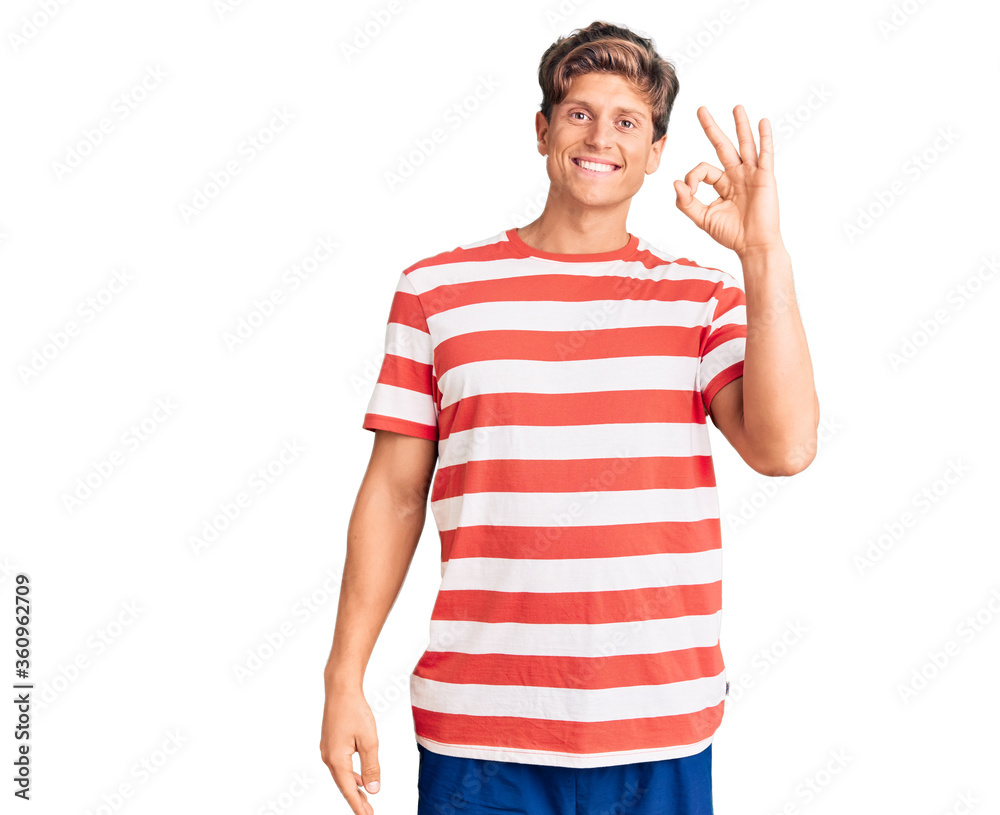 Young handsome man wearing casual clothes smiling positive doing ok sign with hand and fingers. successful expression. Young handsome man wearing casual clothes smiling positive doing ok sign with hand and fingers. successful expression.