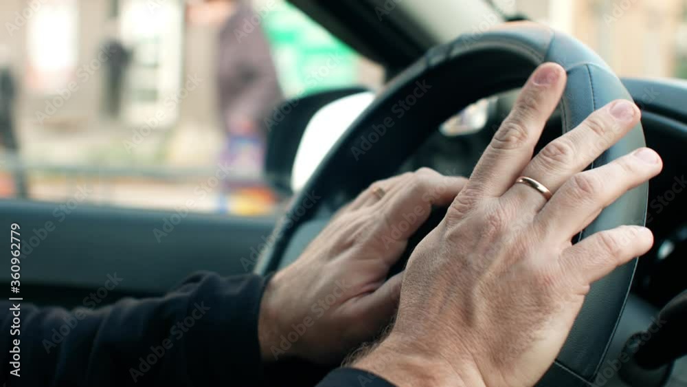 Traffic jam in the city. The driver is in a hurry and nervous at the wheel of a car Traffic jam in the city. The driver is in a hurry and nervous at the wheel of a car