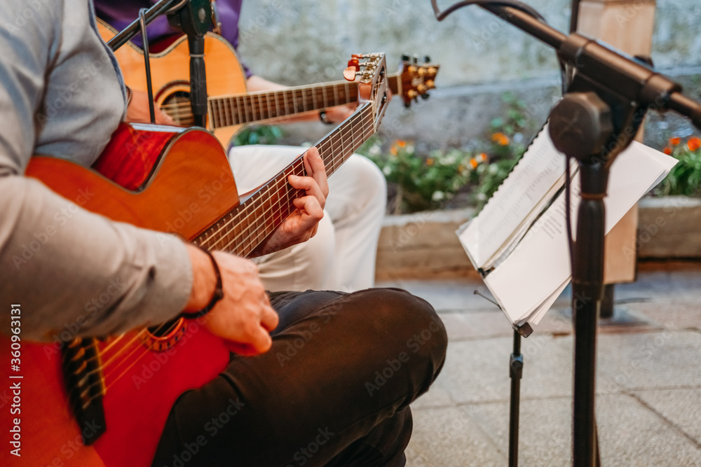 Musician band plays guitar on wedding ceremony hands close up Musician band plays guitar on wedding ceremony hands close up
