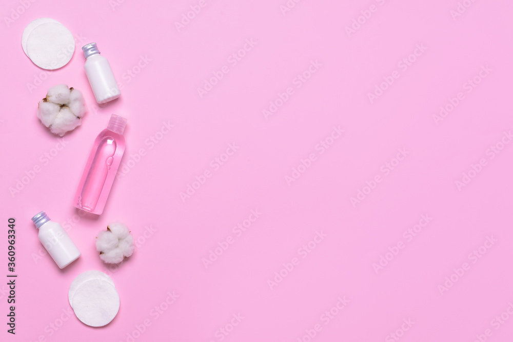 Cotton flowers with cosmetics and pads on color background Cotton flowers with cosmetics and pads on color background