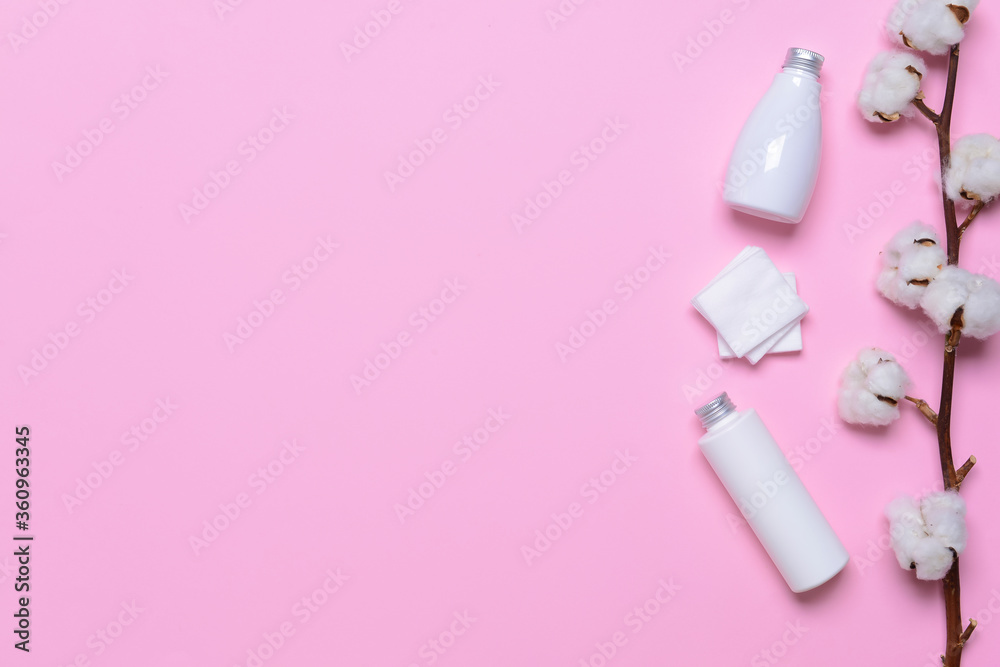 Cotton flowers with cosmetics and pads on color background