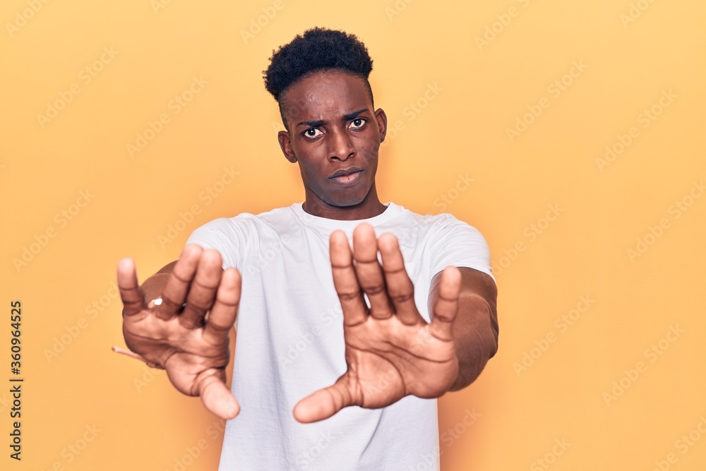 Young african american man wearing casual clothes doing stop gesture with hands palms, angry and frustration expression Young african american man wearing casual clothes doing stop gesture with hands palms, angry and frustration expression