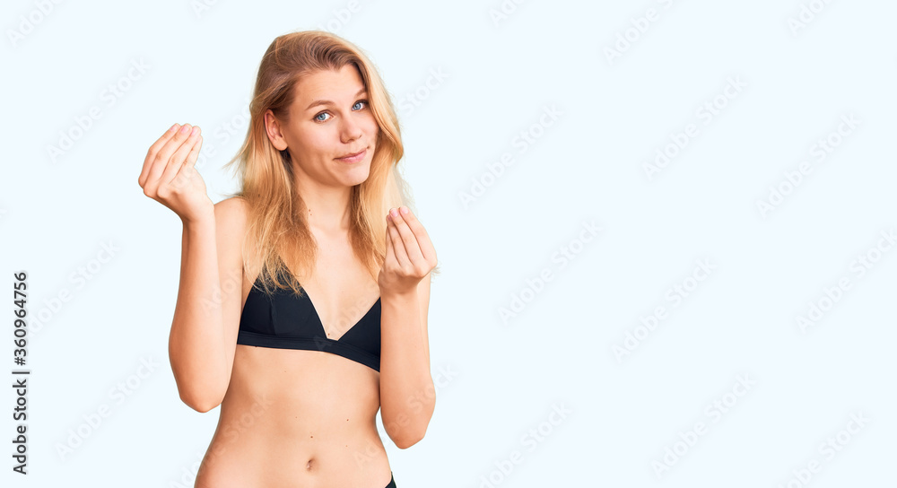 Young beautiful blonde woman wearing bikini doing money gesture with hands,  asking for salary payment, millionaire business foto de Stock | Adobe Stock