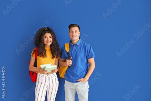 Young students on color bac...