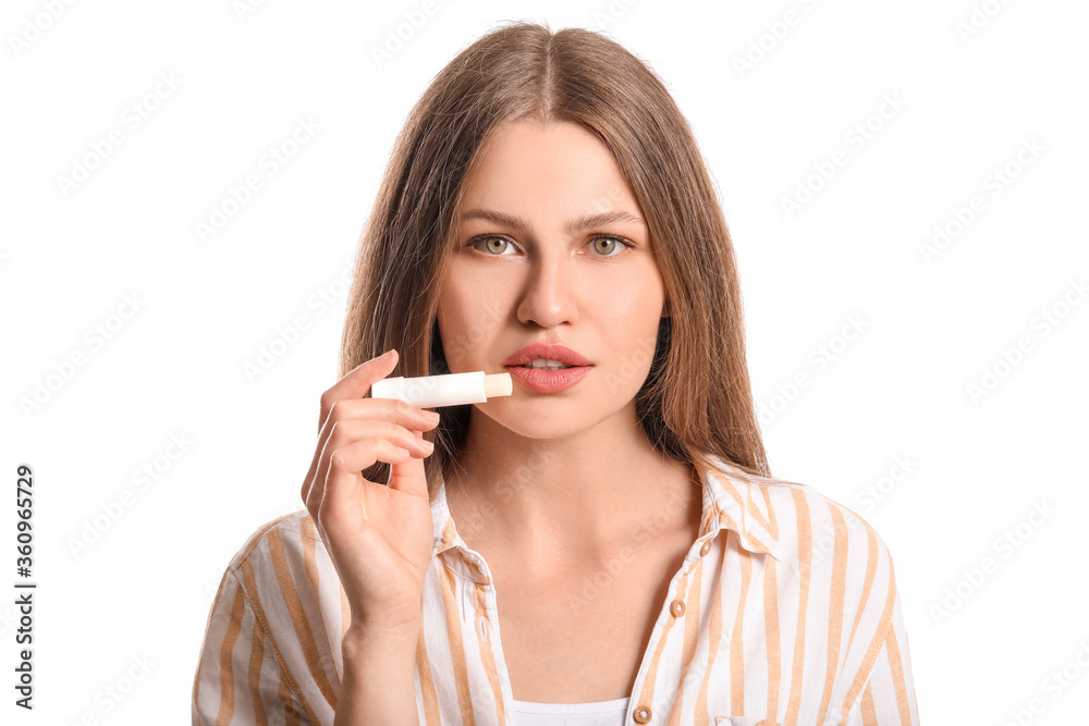 Beautiful young woman with lip balm on white background Beautiful young woman with lip balm on white background
