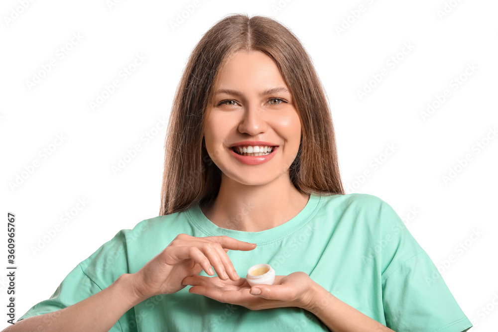 Beautiful young woman with lip balm on white background