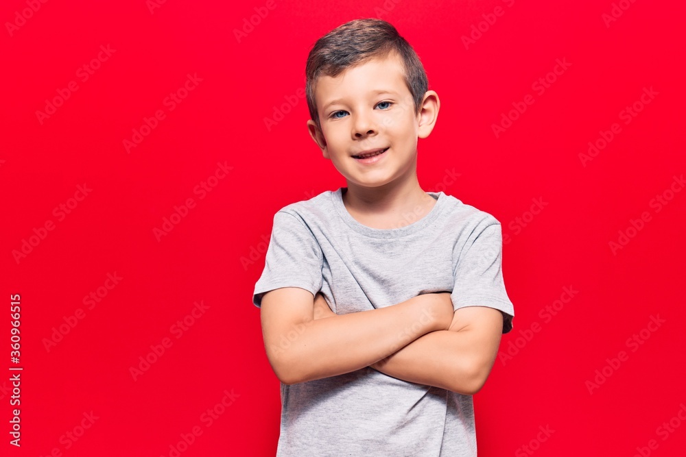 Cute blond kid wearing casual clothes happy face smiling with crossed arms looking at the camera. positive person. Cute blond kid wearing casual clothes happy face smiling with crossed arms looking at the camera. positive person.