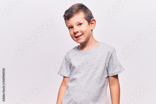 Cute blond kid wearing casual clothes looking positive and happy standing and smiling with a confident smile showing teeth