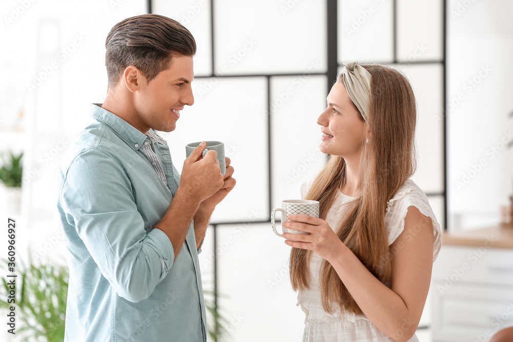 Happy young couple drinking tea at home Happy young couple drinking tea at home