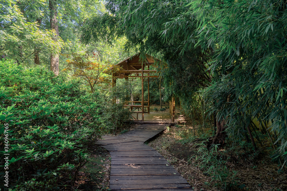 Ancient bamboo cabin and the path, Suzhou garden, in China. Ancient bamboo cabin and the path, Suzhou garden, in China.