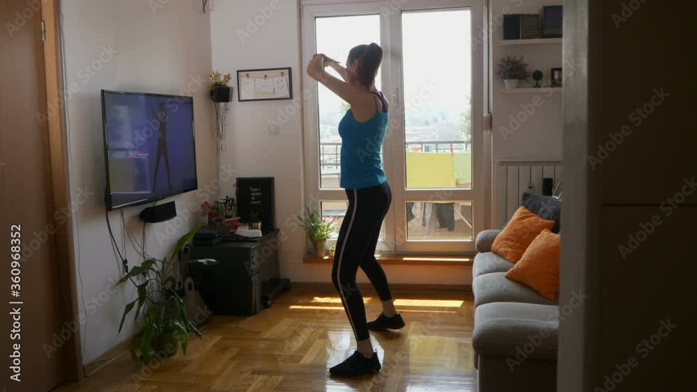 Woman exercise into daily routine while social distancing