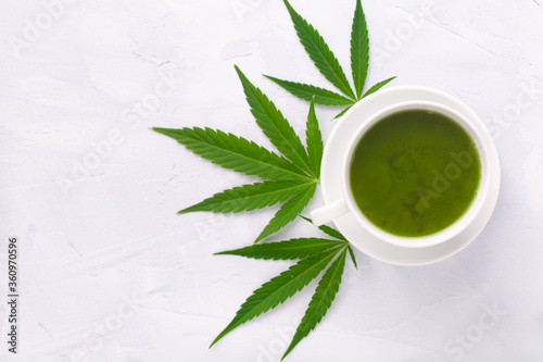 Cannabis CBD tea for the ultimate relaxing hot drink. Overhead photography on white background with marijuana leaf.