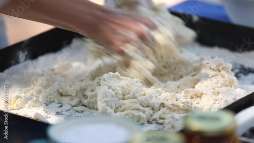 Preparing a focaccia bread with onions and dried tomatoes