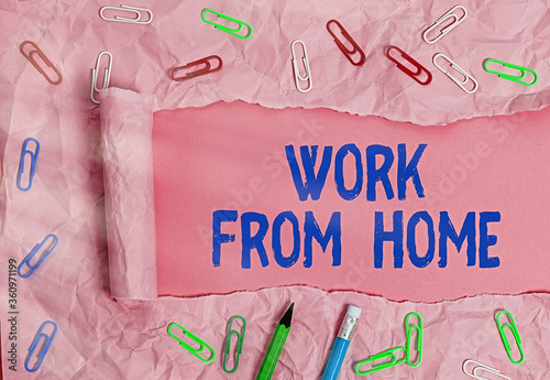 Conceptual hand writing showing Work From Home. Concept meaning communicating with the company mainly from home flexibly Rolled ripped torn cardboard above a wooden classic table photo