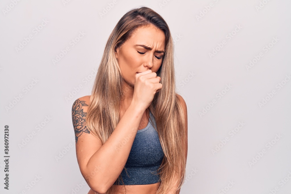 Young beautiful blonde woman wearing casual t-shirt standing over isolated white background feeling unwell and coughing as symptom for cold or bronchitis. Health care concept. Young beautiful blonde woman wearing casual t-shirt standing over isolated white background feeling unwell and coughing as symptom for cold or bronchitis. Health care concept.