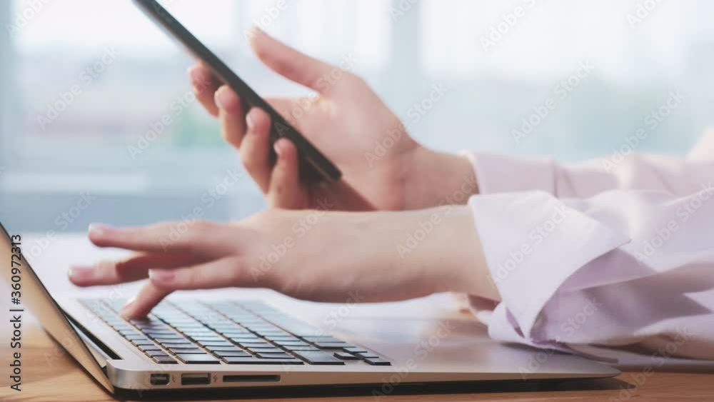 Business technology. Cyber security. Female hands using laptop smartphone for online operation.