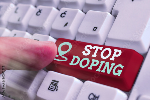 Word writing text Stop Doping. Business photo showcasing quit the use of banned athletic performanceenhancing drugs White pc keyboard with empty note paper above white key copy space photo