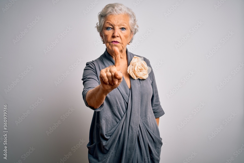 Senior beautiful grey-haired woman wearing casual dress standing over white background Pointing with finger up and angry expression, showing no gesture