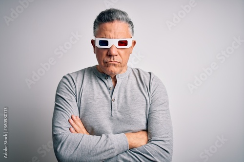 Middle age handsome grey-haired man using 3d glasses over isolated white background skeptic and nervous, disapproving expression on face with crossed arms. Negative person.