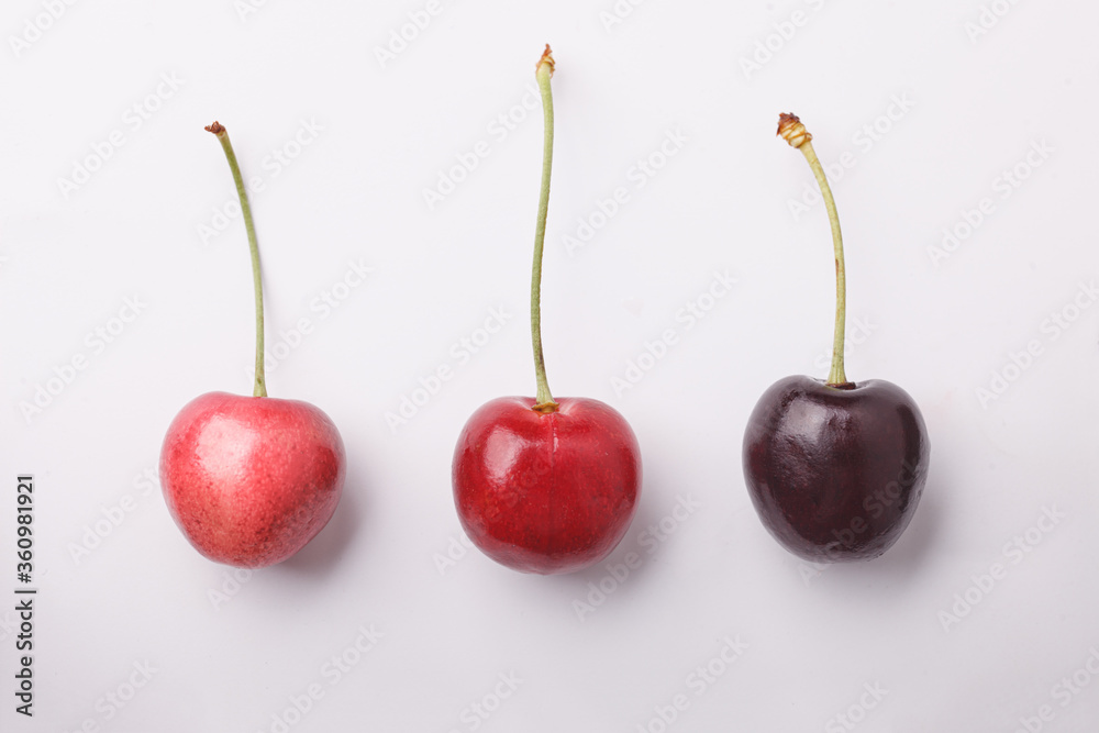 three different cherry light and dark on white background, diversity concept three different cherry light and dark on white background, diversity concept