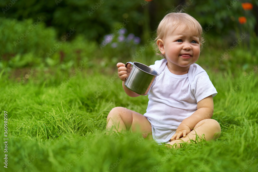 child with a mug of drink outdoors child with a mug of drink outdoors