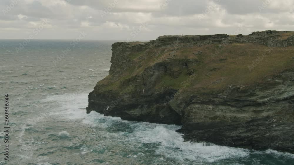 waves crashing against huge coastal cliffs