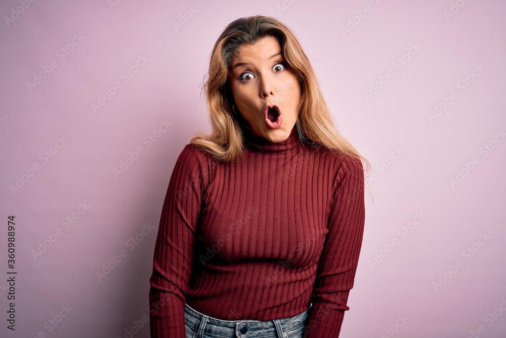 Young beautiful blonde woman wearing casual sweater over isolated pink background afraid and shocked with surprise expression, fear and excited face. Young beautiful blonde woman wearing casual sweater over isolated pink background afraid and shocked with surprise expression, fear and excited face.