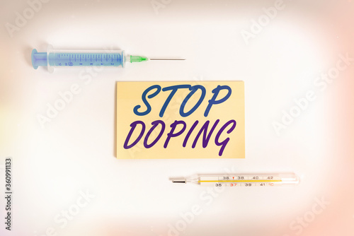 Text sign showing Stop Doping. Business photo showcasing quit the use of banned athletic performanceenhancing drugs Set of medical equipment with notepad for health condition assessment photo