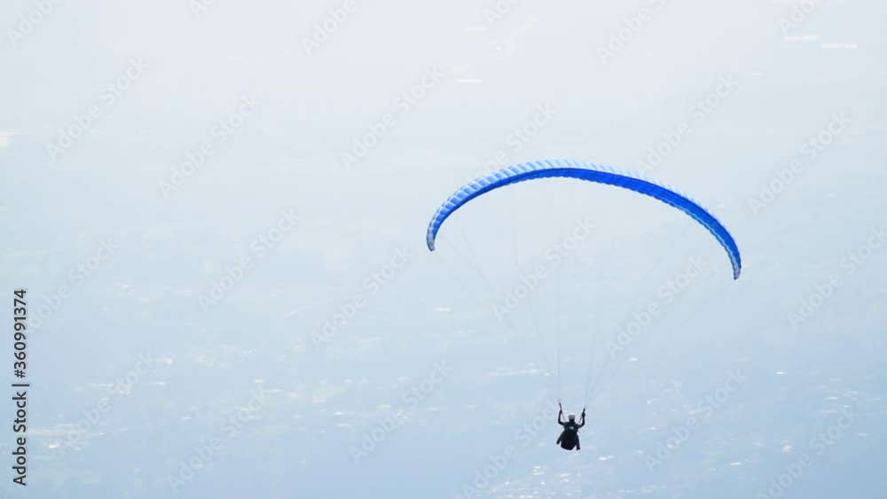Skydiver paraglider. Beautiful tranquil and calm time in nature over town and highway daylight. Adrenaline, extreme sport. Skydiver paraglider. Beautiful tranquil and calm time in nature over town and highway daylight. Adrenaline, extreme sport.